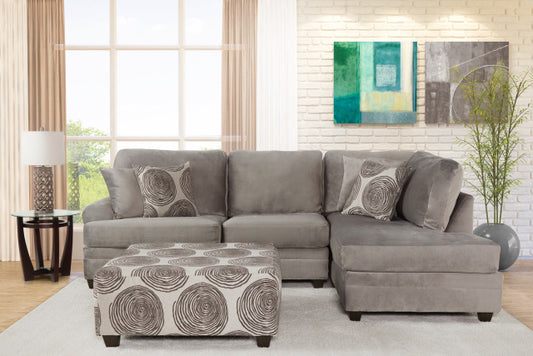 Gray sectional sofa with matching ottoman in a living room setting.
