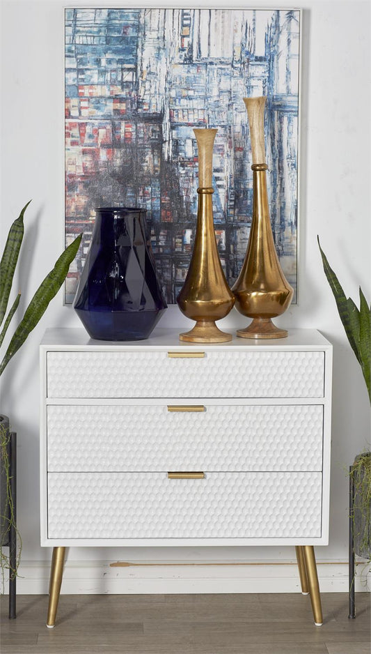White and gold cabinet styled in a modern bedroom or luxury entryway