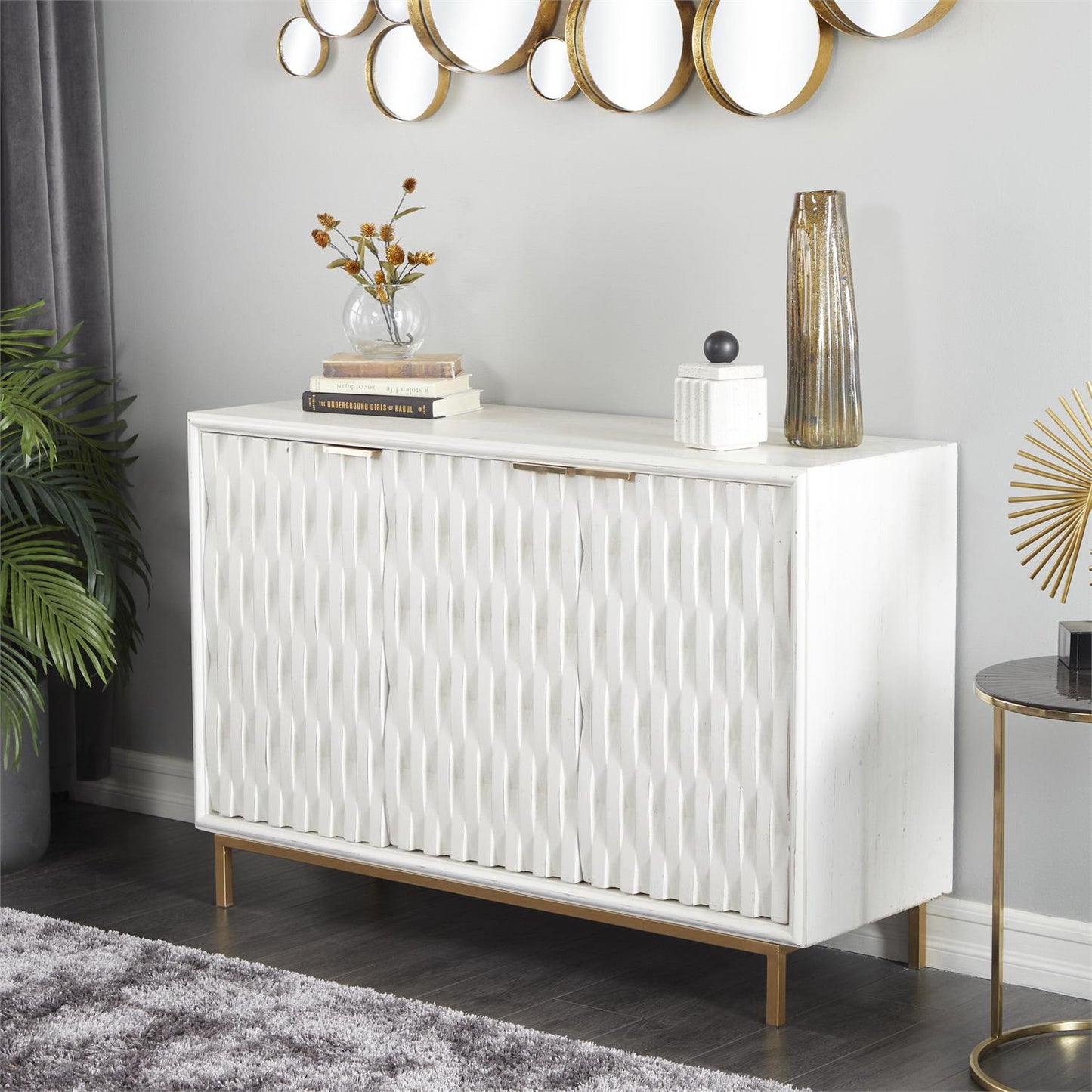 Luxury white cabinet styled in a modern entryway or living room with gold accents