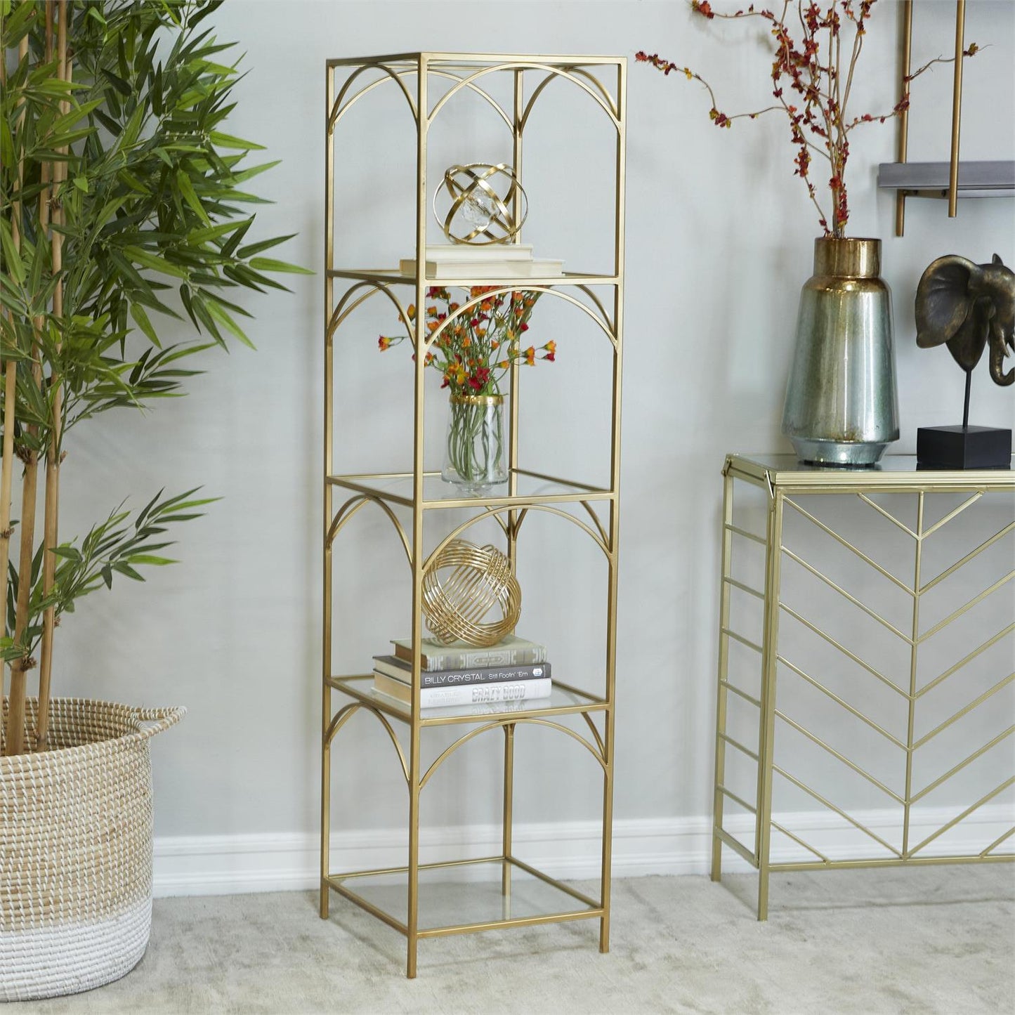 Gold glass shelf styled in minimalist living room with modern decor