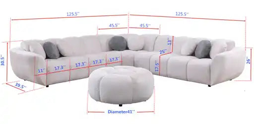Beige fabric channel-tufted sectional sofa with round ottoman and accent pillows in a modern living room