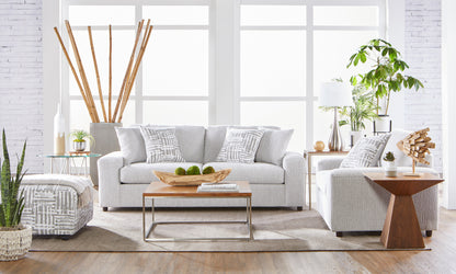 Light gray textured sofa and loveseat living room set with matching accent pillows and modern décor.