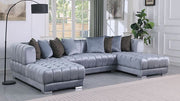 Grey velvet channel-tufted sectional sofa with silver legs and accent pillows