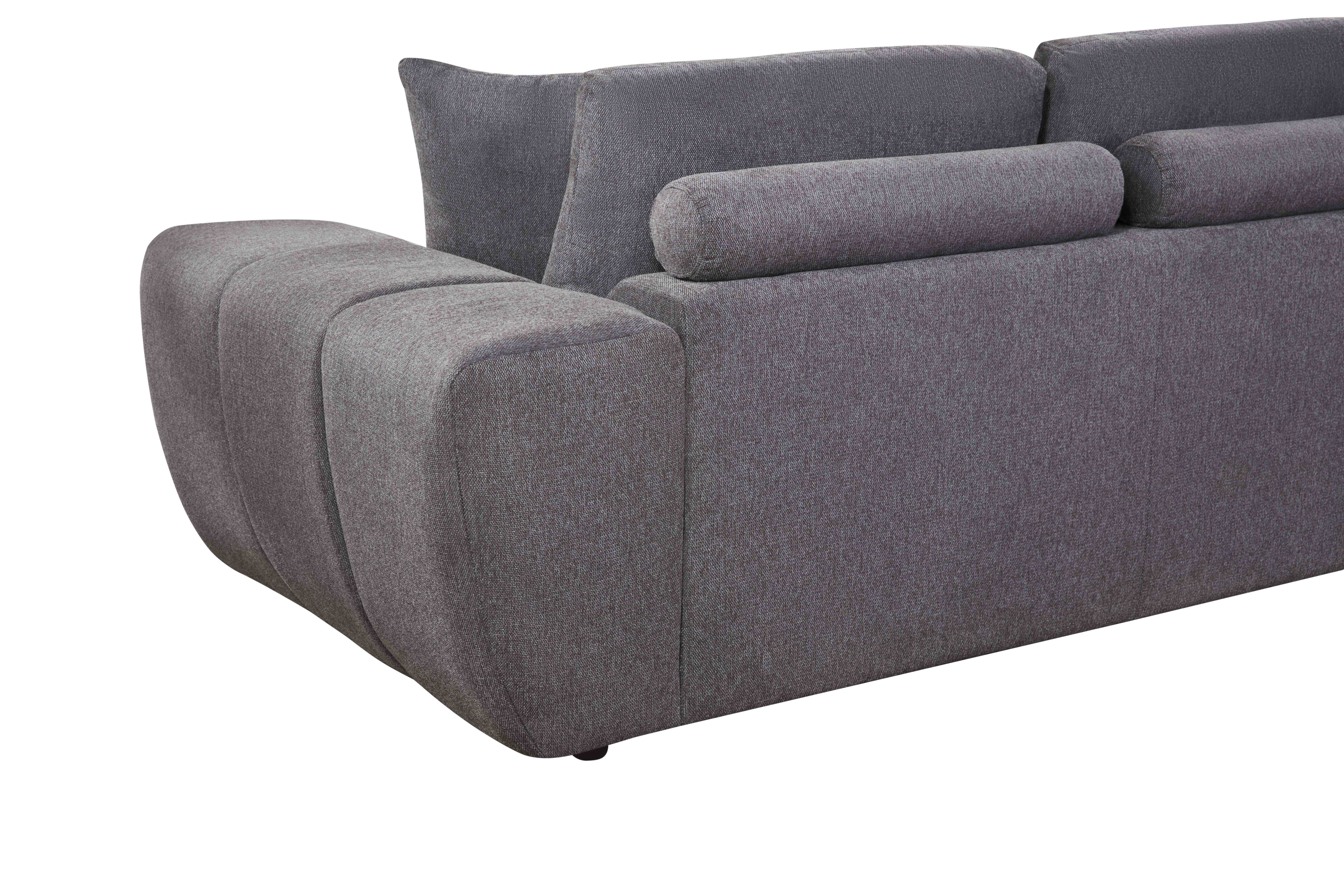 Grey L-shaped sectional sofa with vertical channeling and bolster cushions in a modern living room