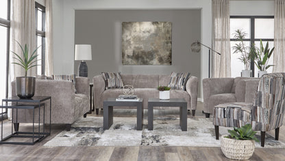 Earth textured sofa and loveseat set with modern curved arms and striped accent pillows