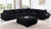 Black textured sectional sofa with Bluetooth console, ottoman, and stainless steel legs in a modern living room