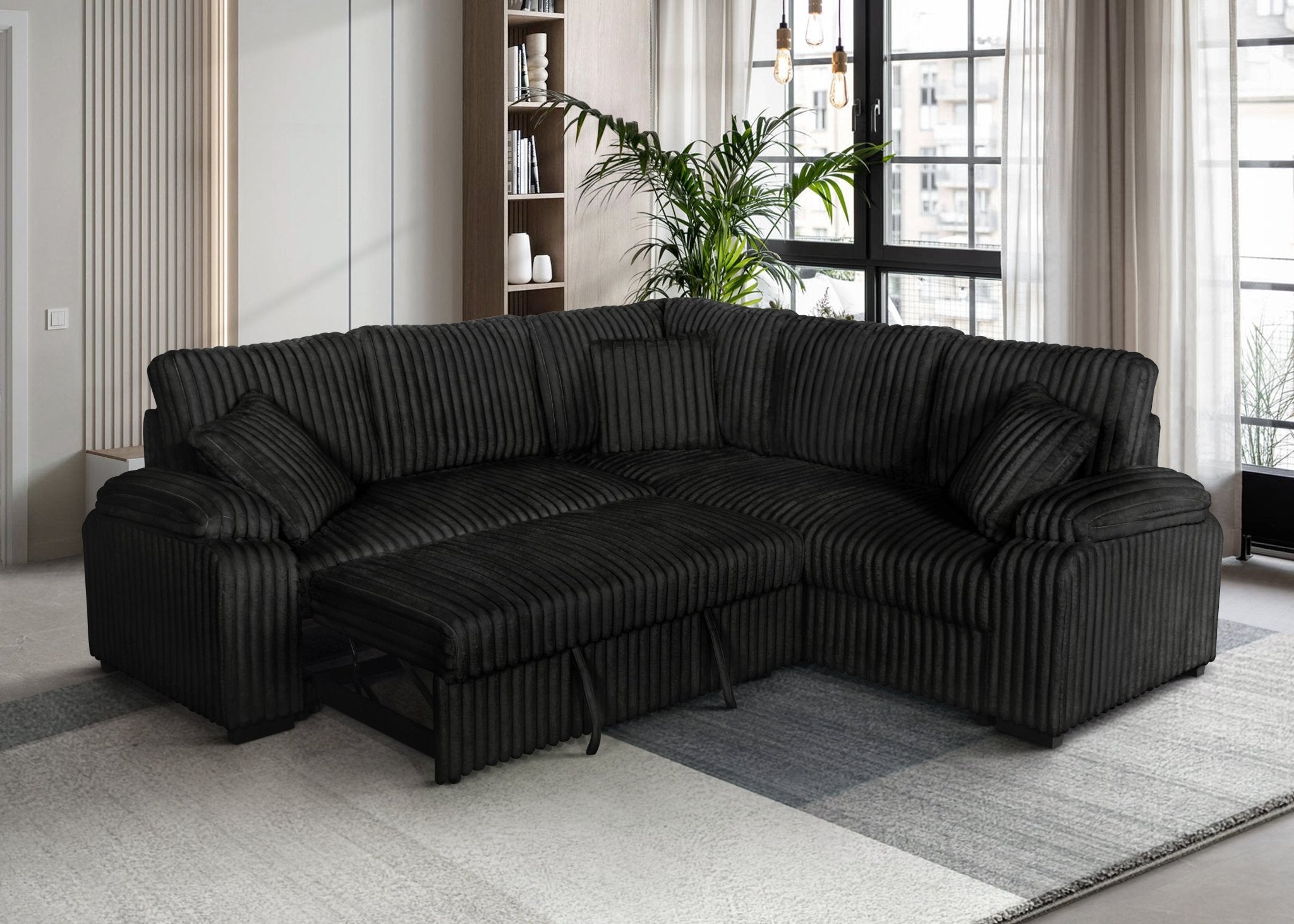 Black corduroy sectional sofa with pullout bed and matching pillows in modern living room