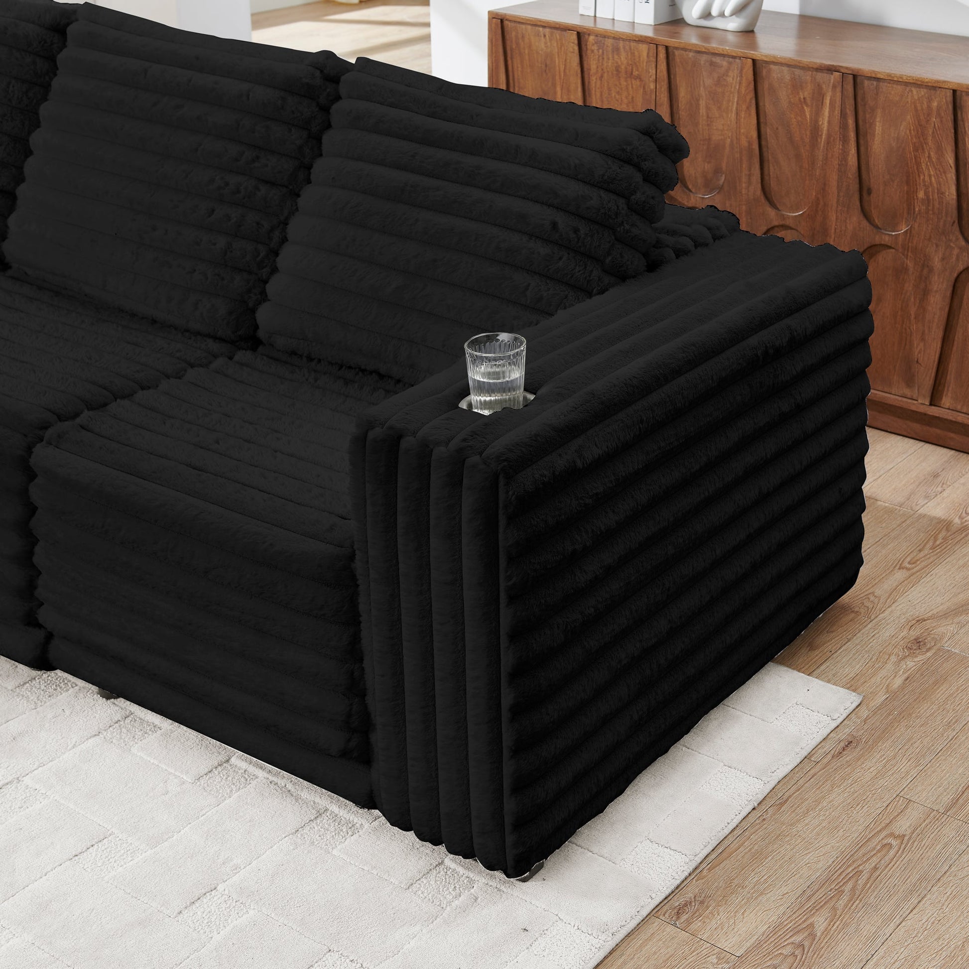 S101 Nuve black modular sectional sofa with ottomans in a living room