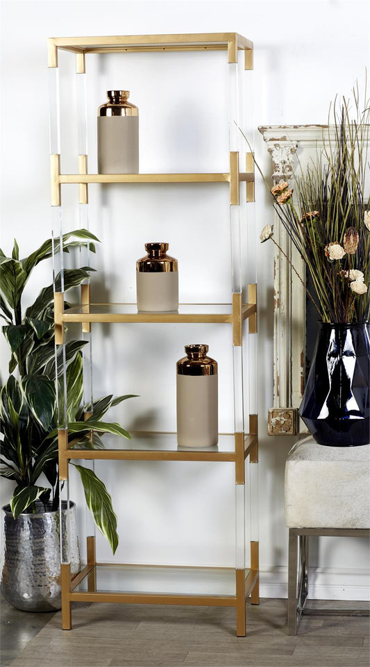 Minimalist gold and acrylic shelving unit styled in modern living room