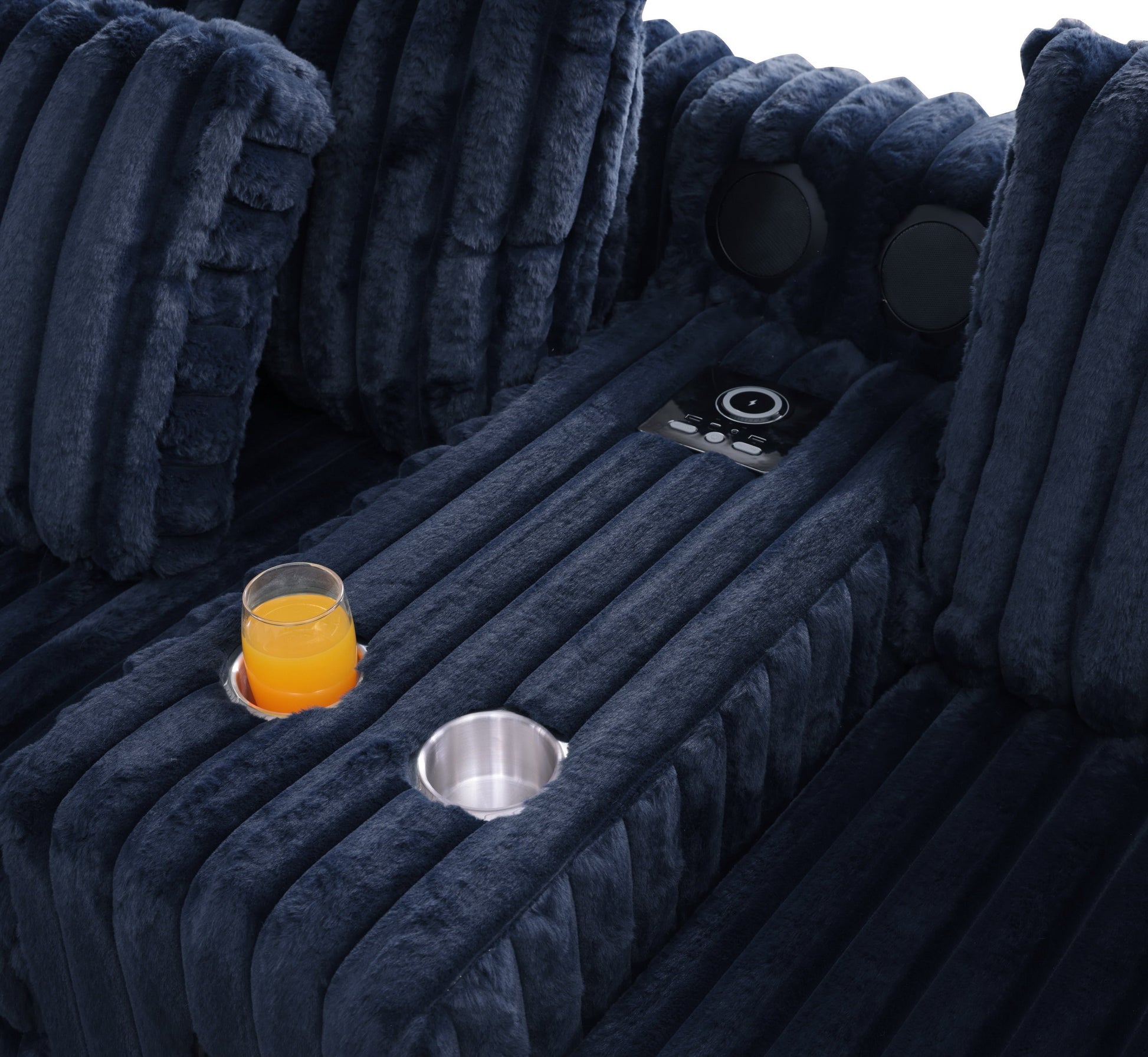 Blue textured sectional sofa with Bluetooth console, cupholders, and ottoman in a living room