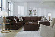 Chocolate brown transitional sectional sofa with corner chaise and matching ottoman in a living room setting