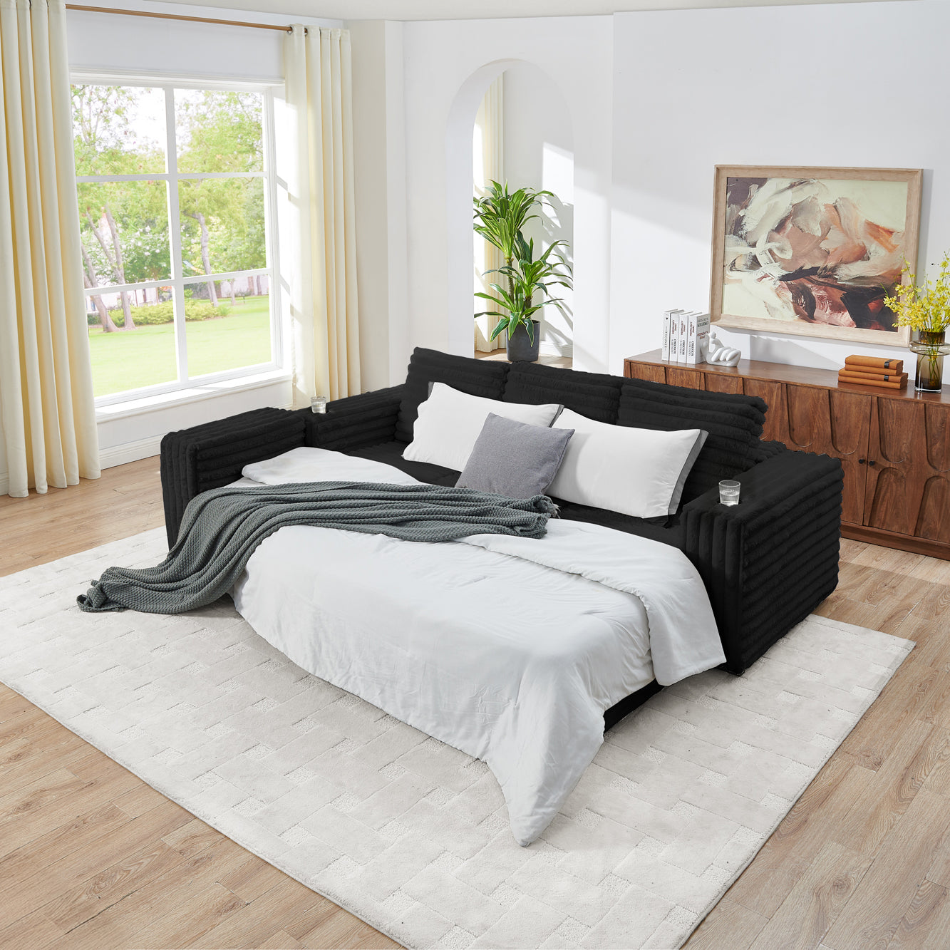 S101 Nuve black modular sectional sofa with ottomans in a living room