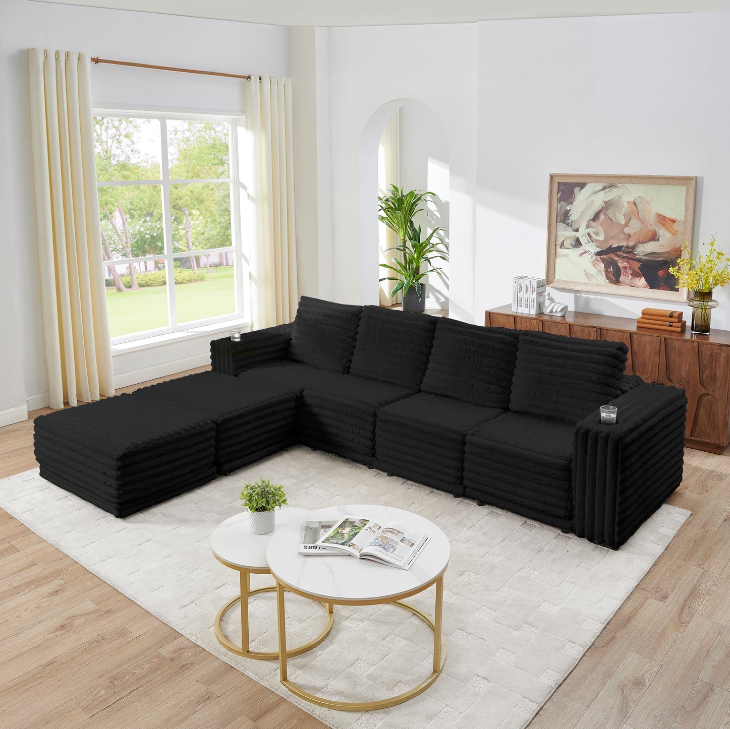 S101 Nuve black modular sectional sofa with ottomans in a living room