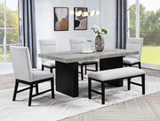 Sebastian dining set with textured tabletop, black base, upholstered chairs and matching bench