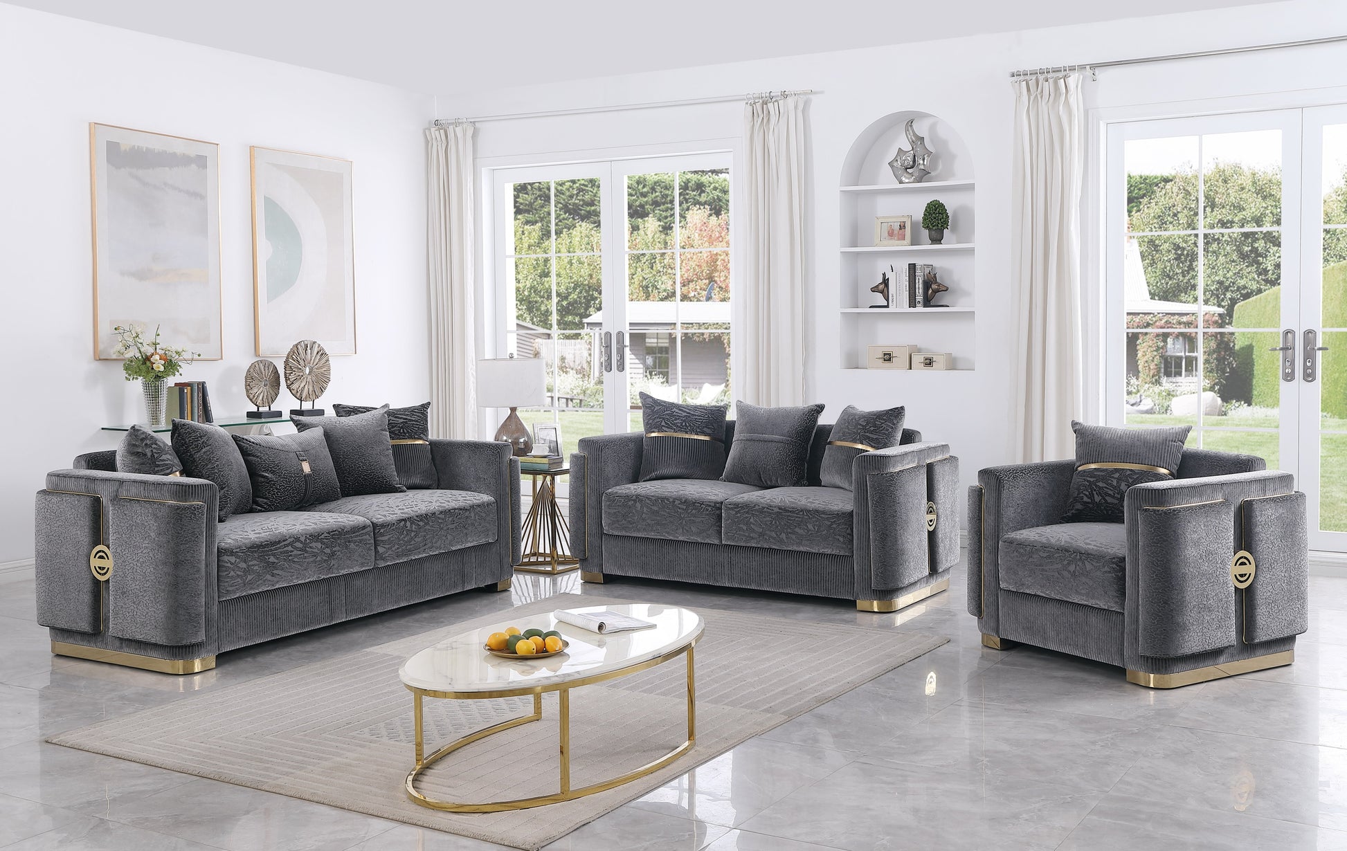 Capri Collection grey sofa, loveseat, and chair set with gold-tone trim and designer pillows in a modern living room