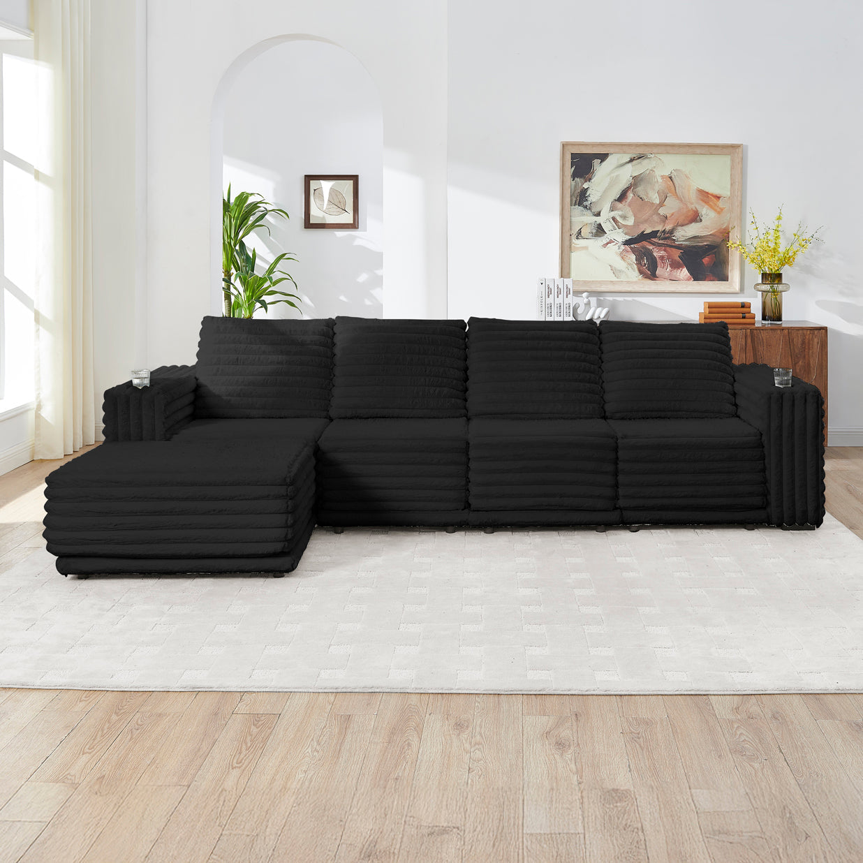 S101 Nuve black modular sectional sofa with ottomans in a living room