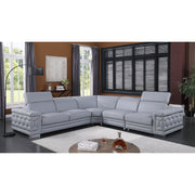 Favo 4-piece light blue-grey Italian leather sectional sofa with hexagon-tufted arms and chrome trim in a modern living room