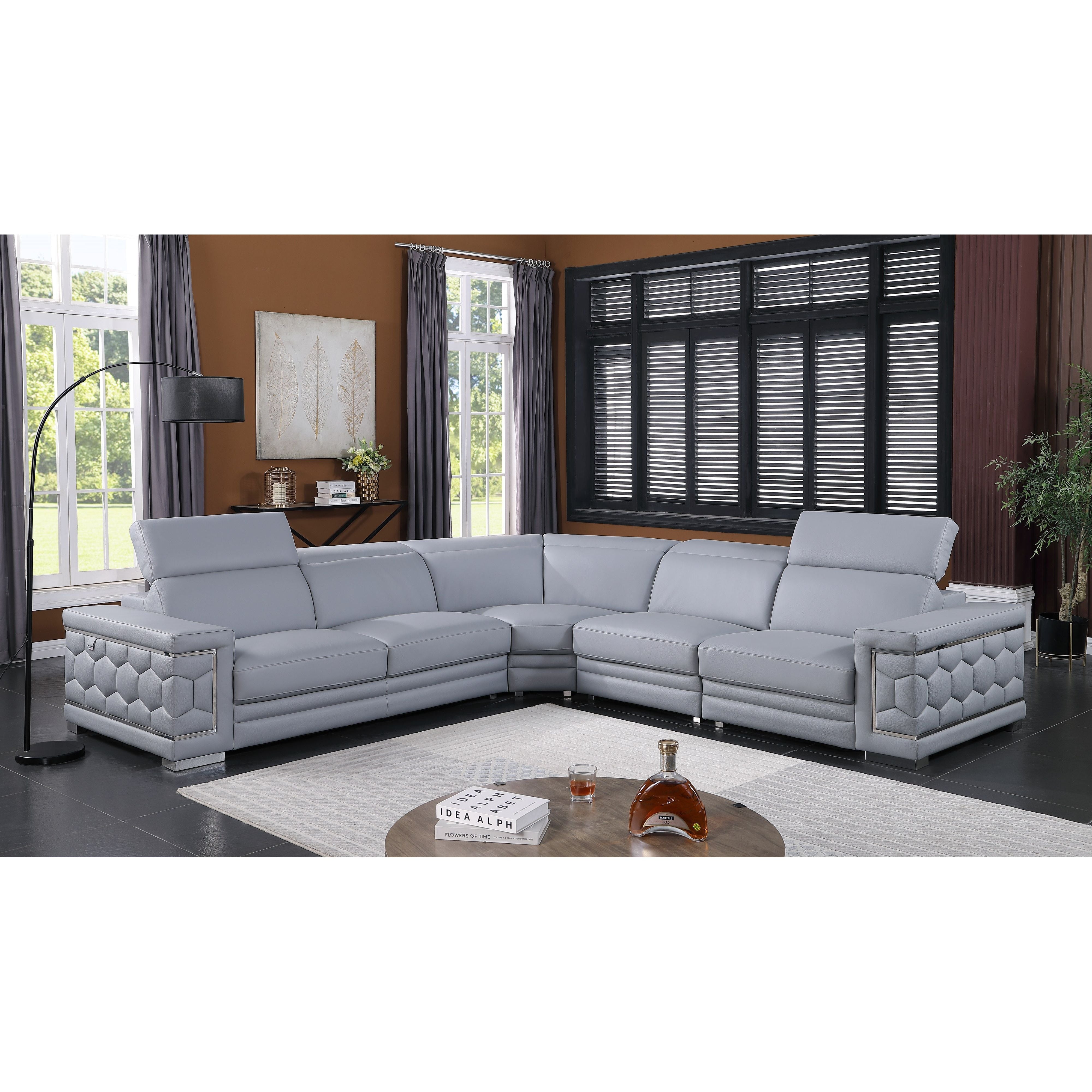Favo 4-piece light blue-grey Italian leather sectional sofa with hexagon-tufted arms and chrome trim in a modern living room