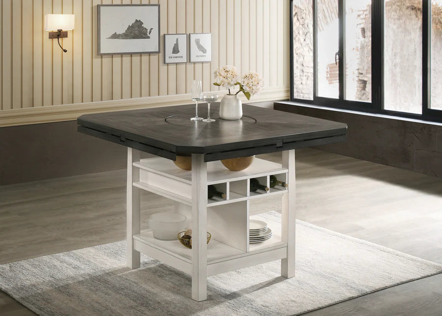 Dining table with a dark top and white base in a room with striped wallpaper and large windows.