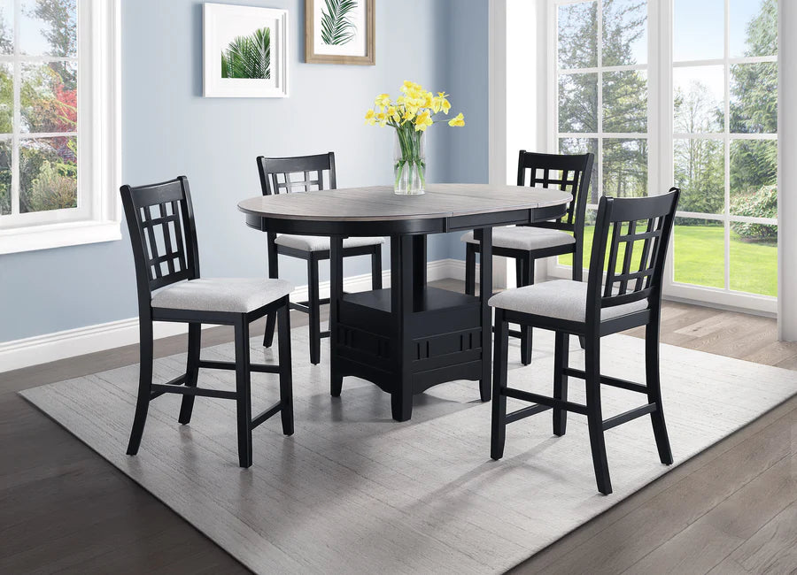 Black dining table with four chairs in a room with large windows.