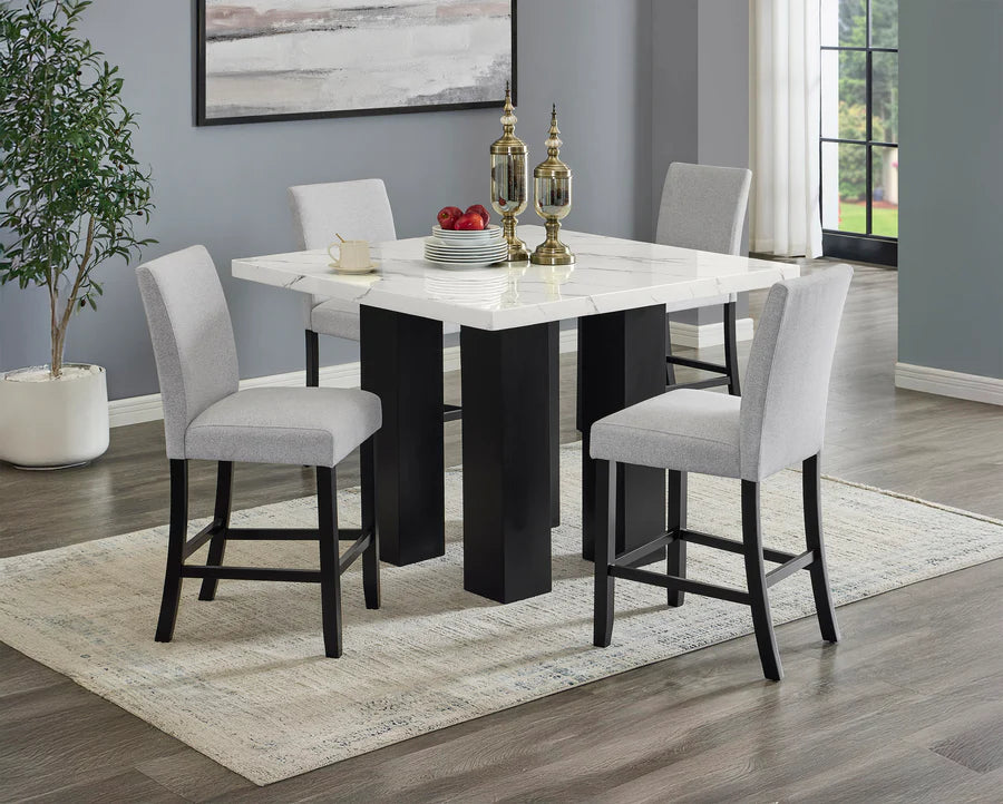 Dining room with a modern table and chairs in a well-lit room.