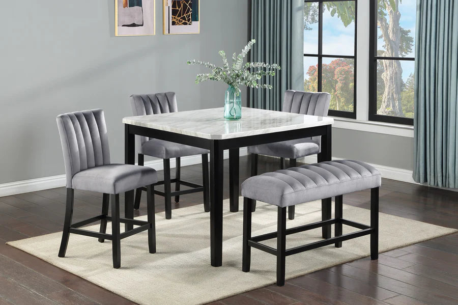 Dining room set with a marble table and gray chairs in a well-lit room.