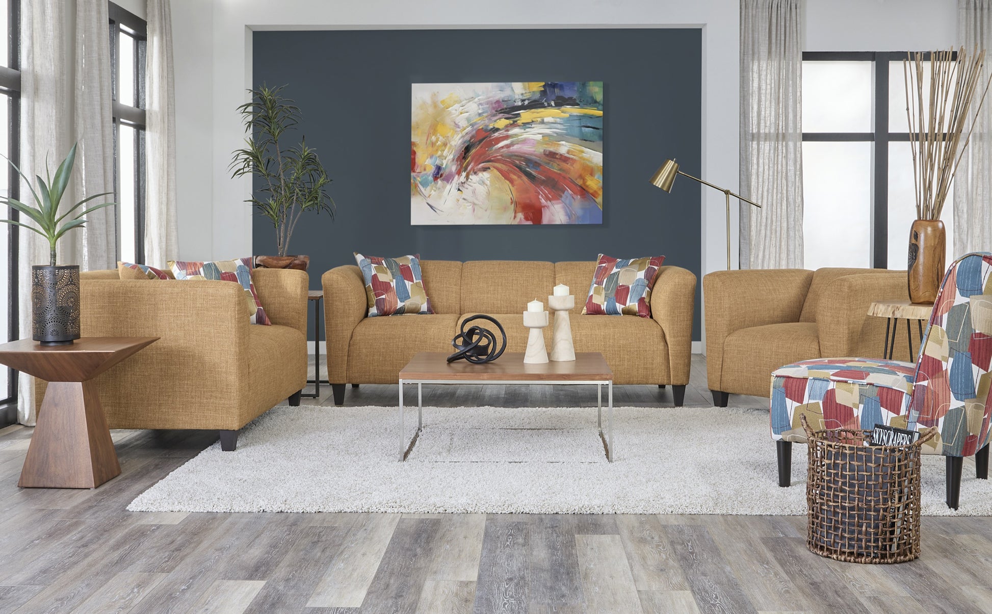 Mustard yellow modern sofa and loveseat set with curved arms and multicolor accent pillows