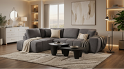 Grey L-shaped sectional sofa with vertical channeling and bolster cushions in a modern living room