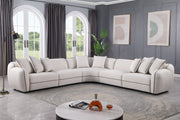 Gaby 5-piece beige fabric sectional sofa with contrast piping and accent pillows in a living room