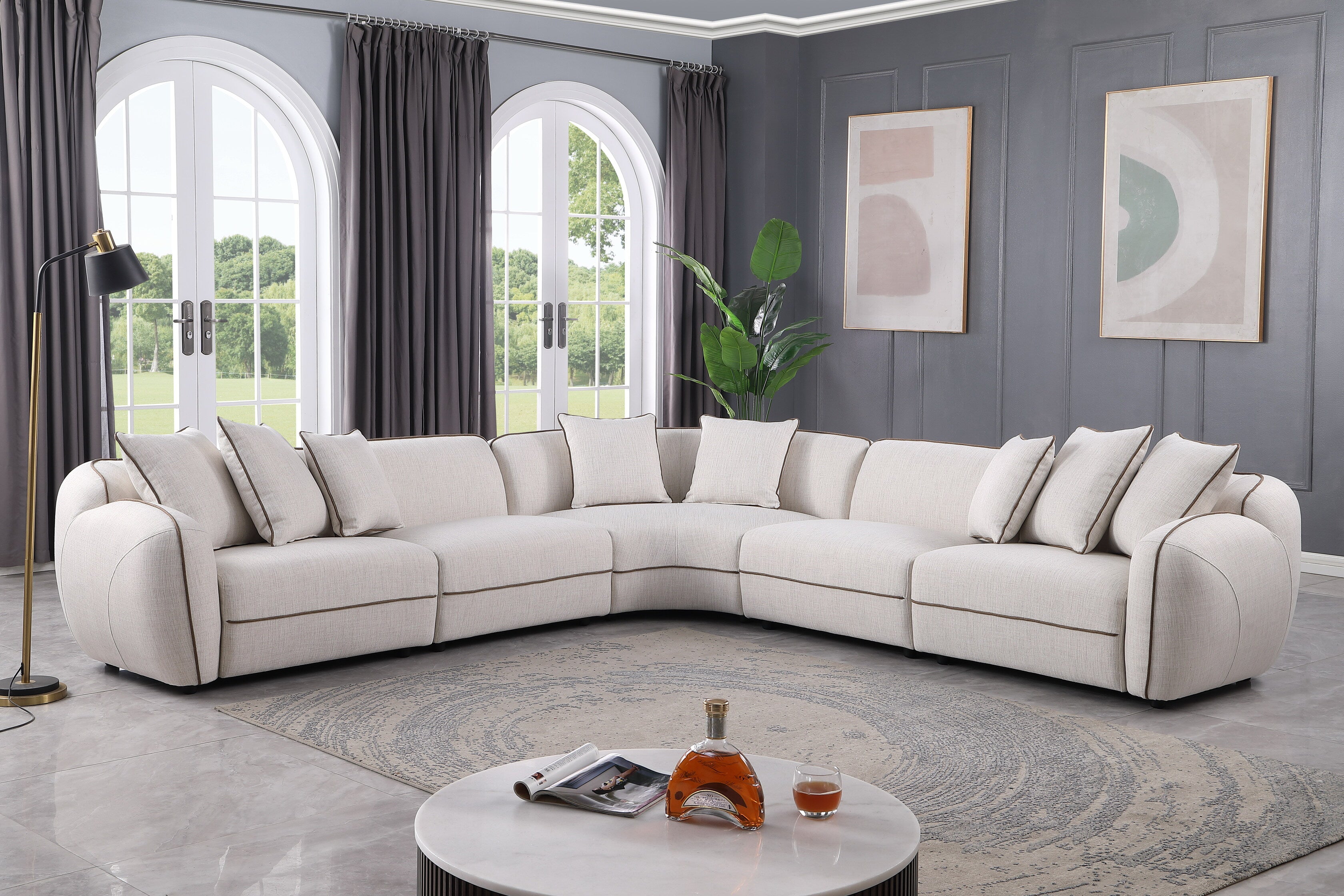 Gaby 5-piece beige fabric sectional sofa with contrast piping and accent pillows in a living room