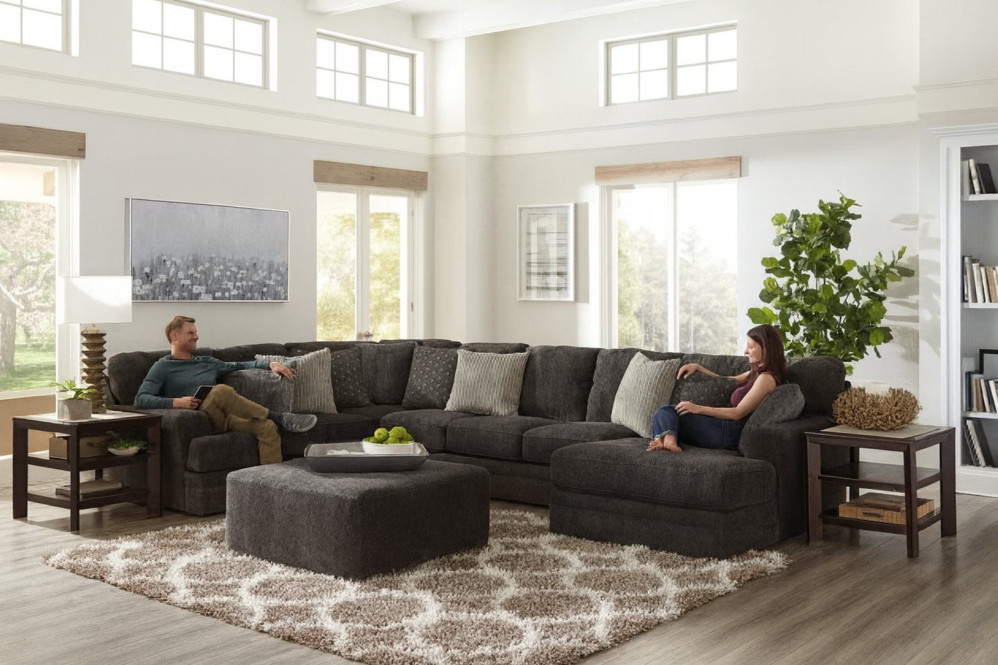 Living room with a gray sectional sofa, ottoman, and decorative items.
