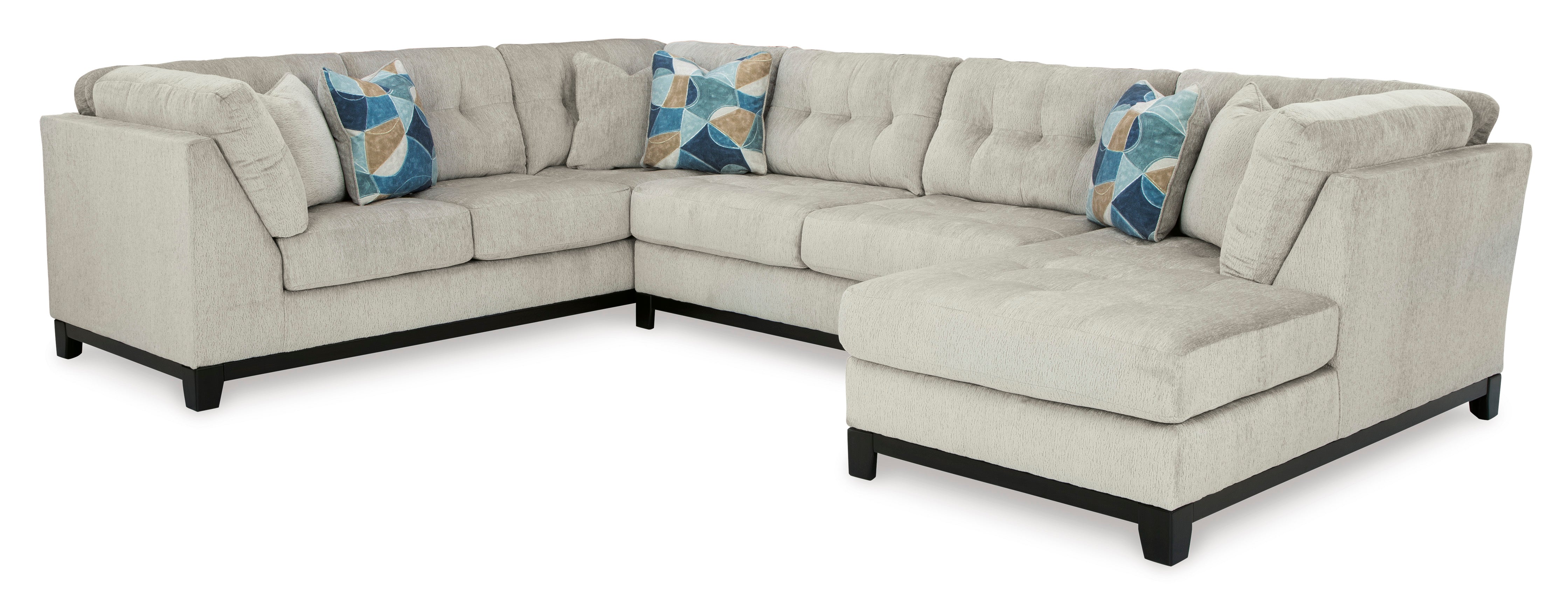 Stone-colored 3-piece sectional sofa with chaise and tufted cushions in a modern living room