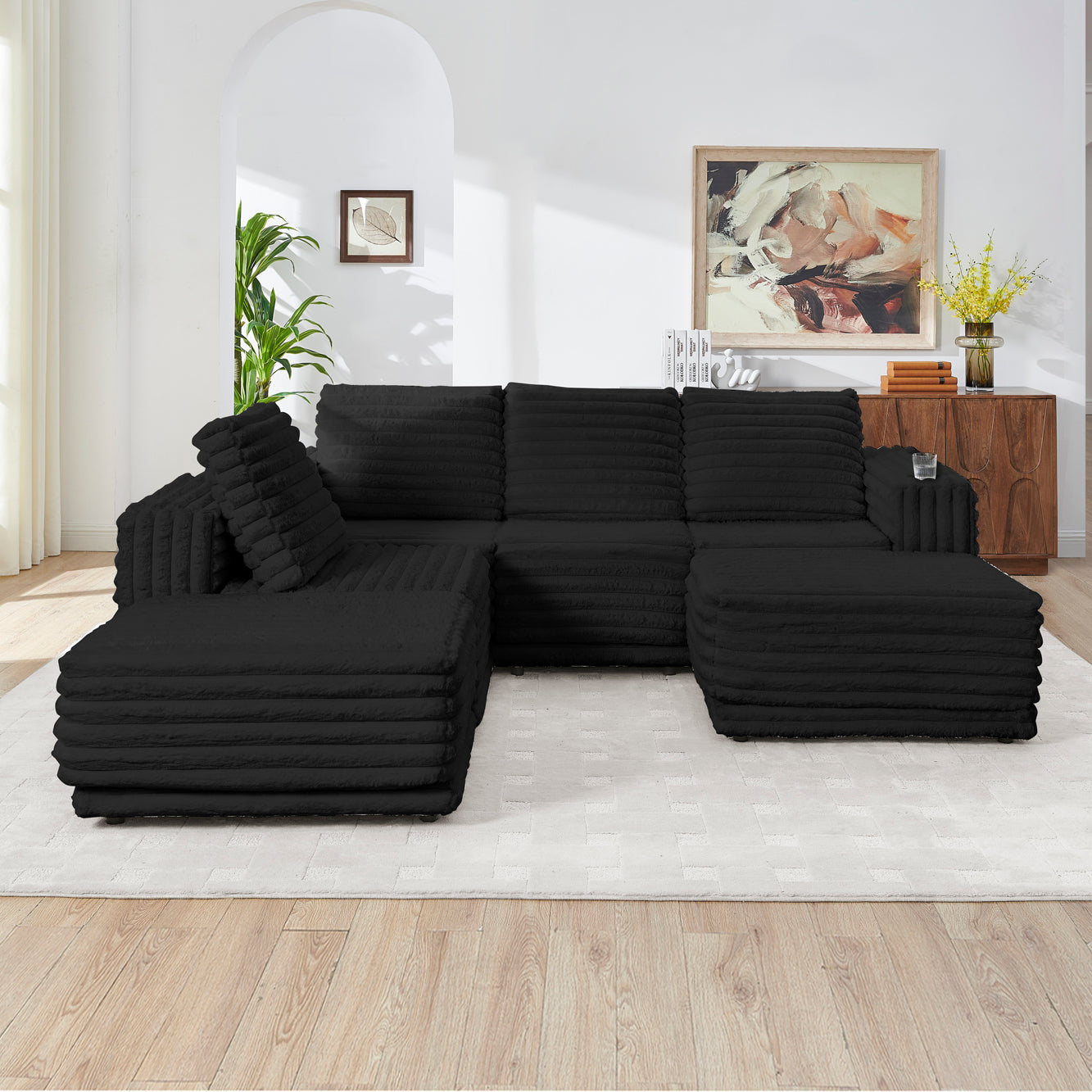 S101 Nuve black modular sectional sofa with ottomans in a living room