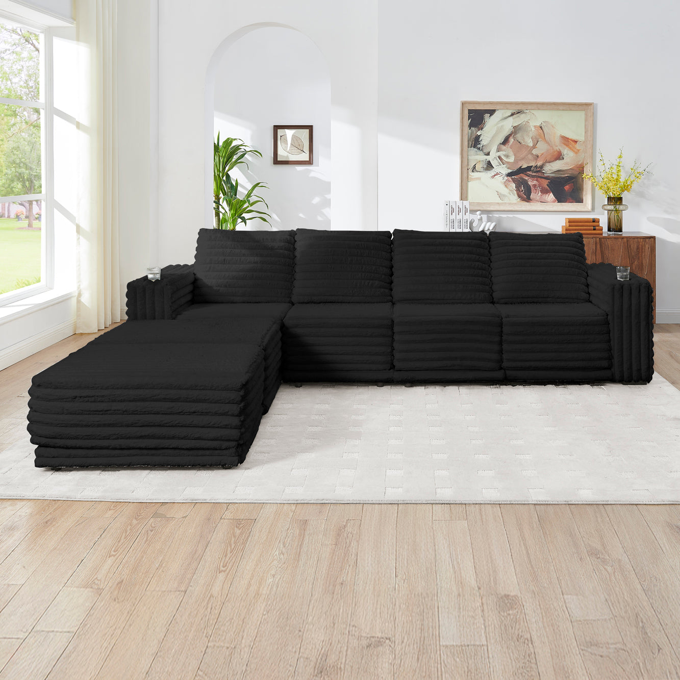 S101 Nuve black modular sectional sofa with ottomans in a living room