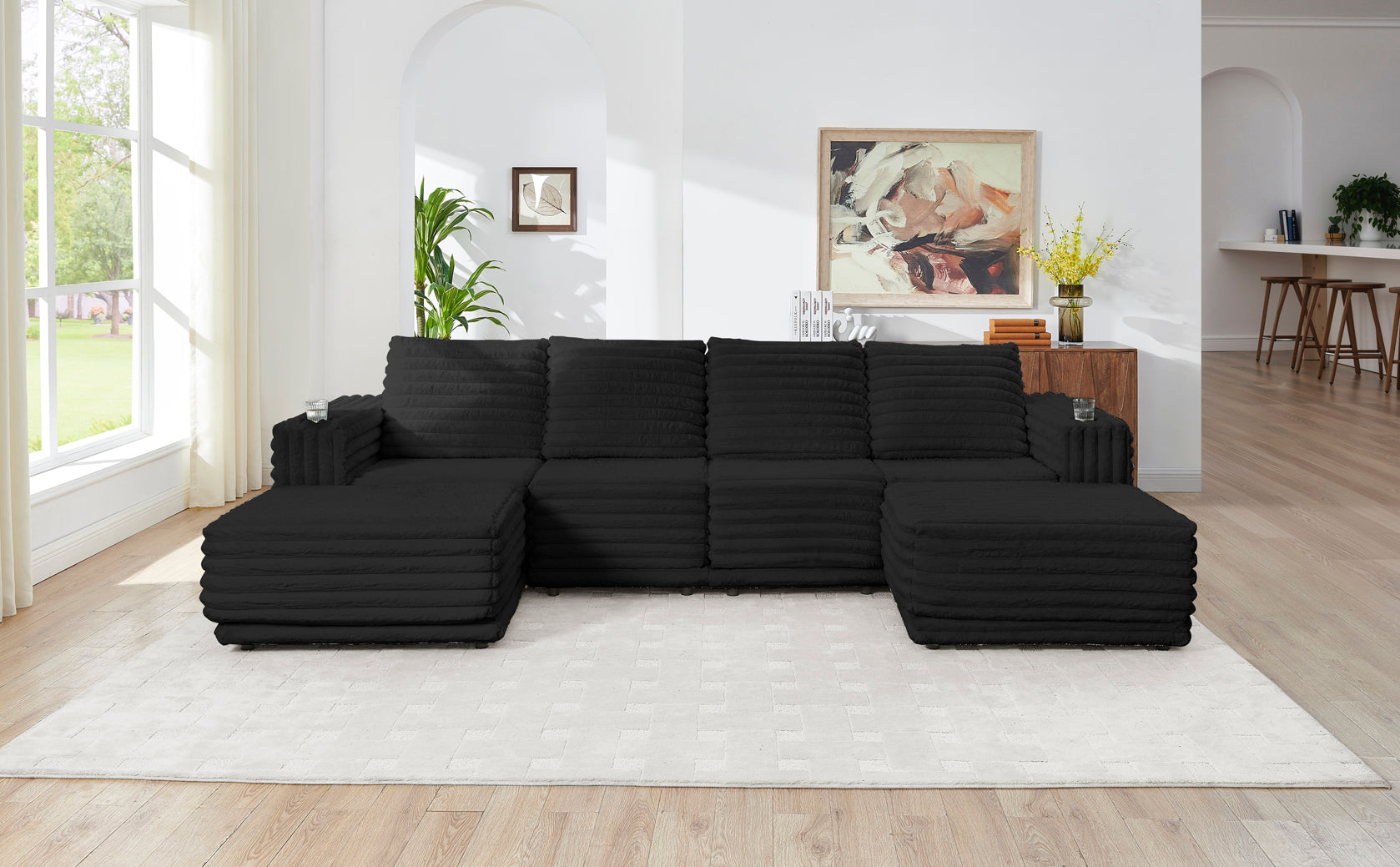 S101 Nuve black modular sectional sofa with ottomans in a living room