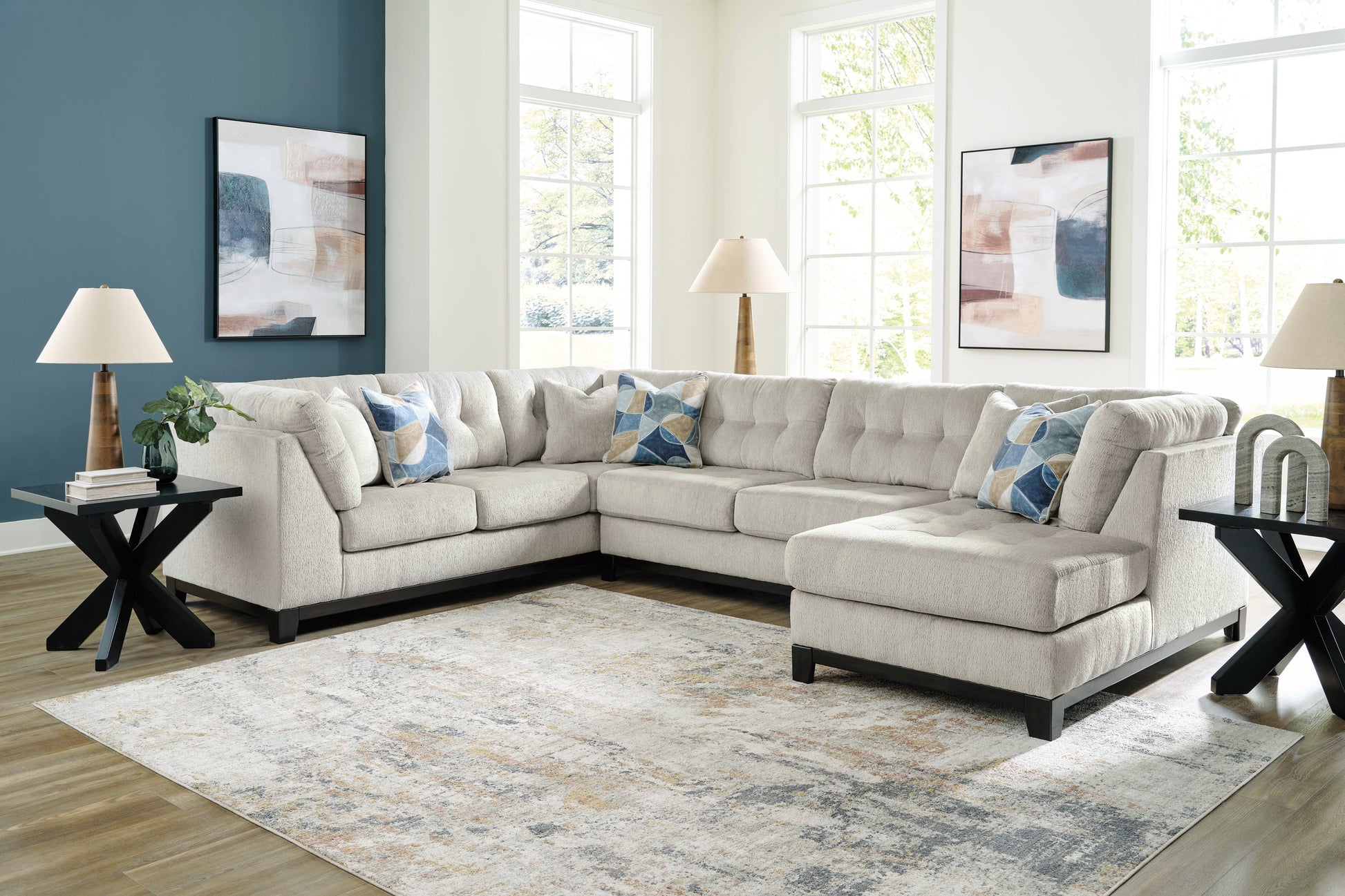 Stone-colored 3-piece sectional sofa with chaise and tufted cushions in a modern living room