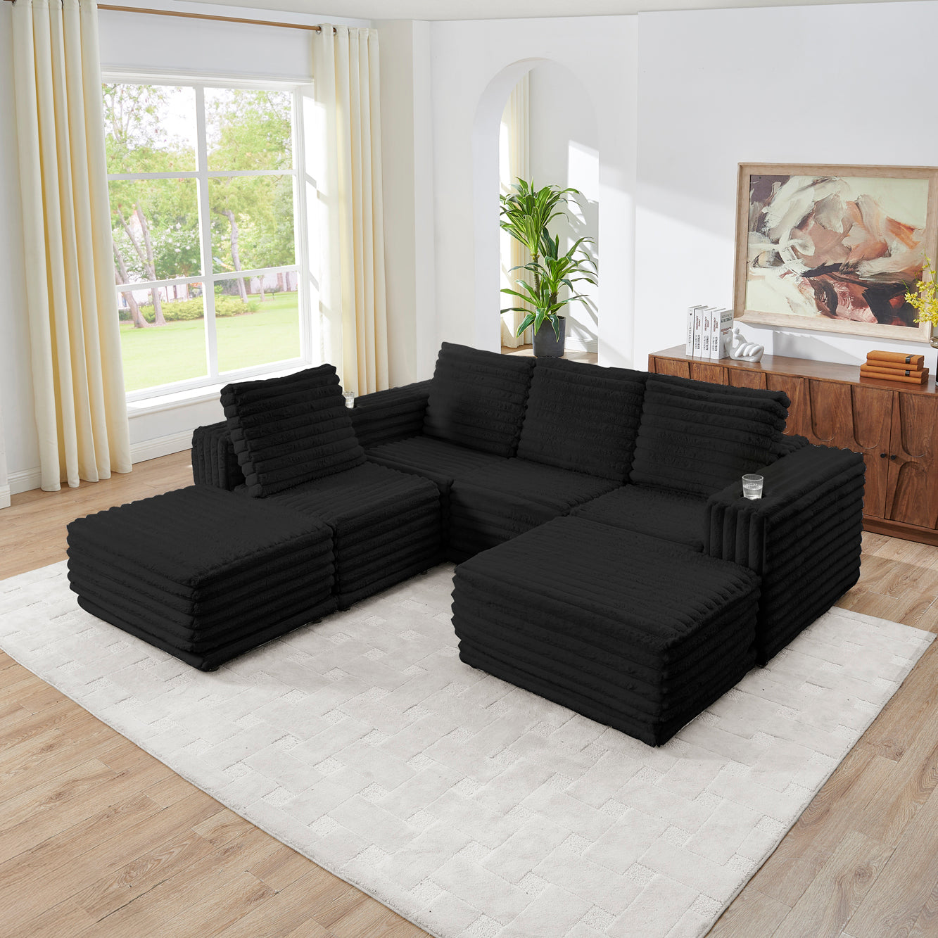 S101 Nuve black modular sectional sofa with ottomans in a living room