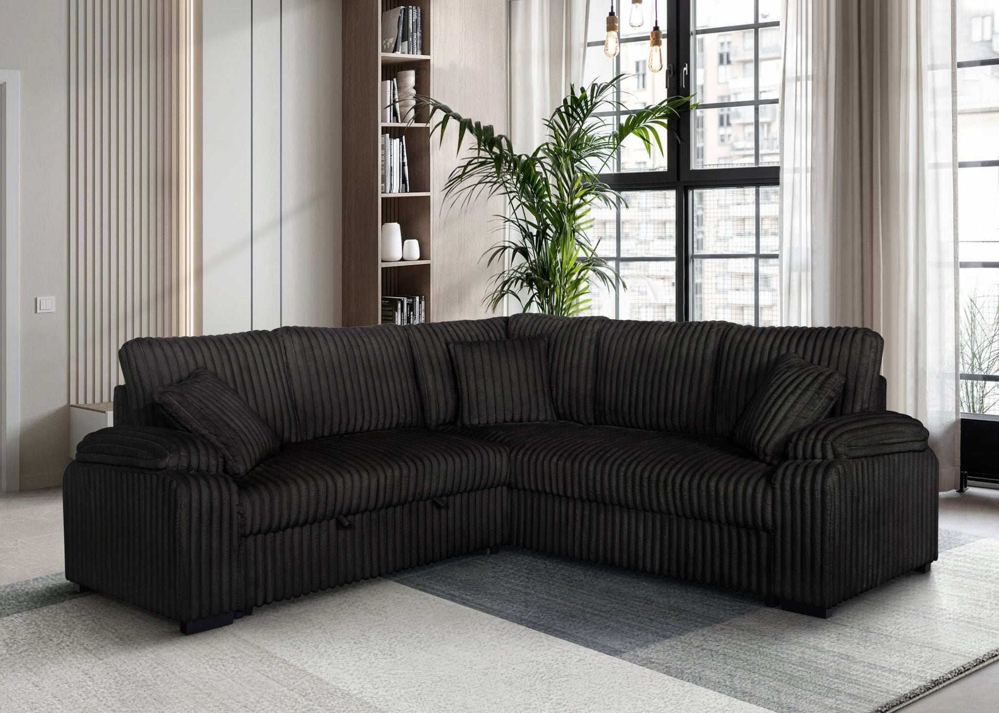 Black corduroy sectional sofa with pullout bed and matching pillows in modern living room