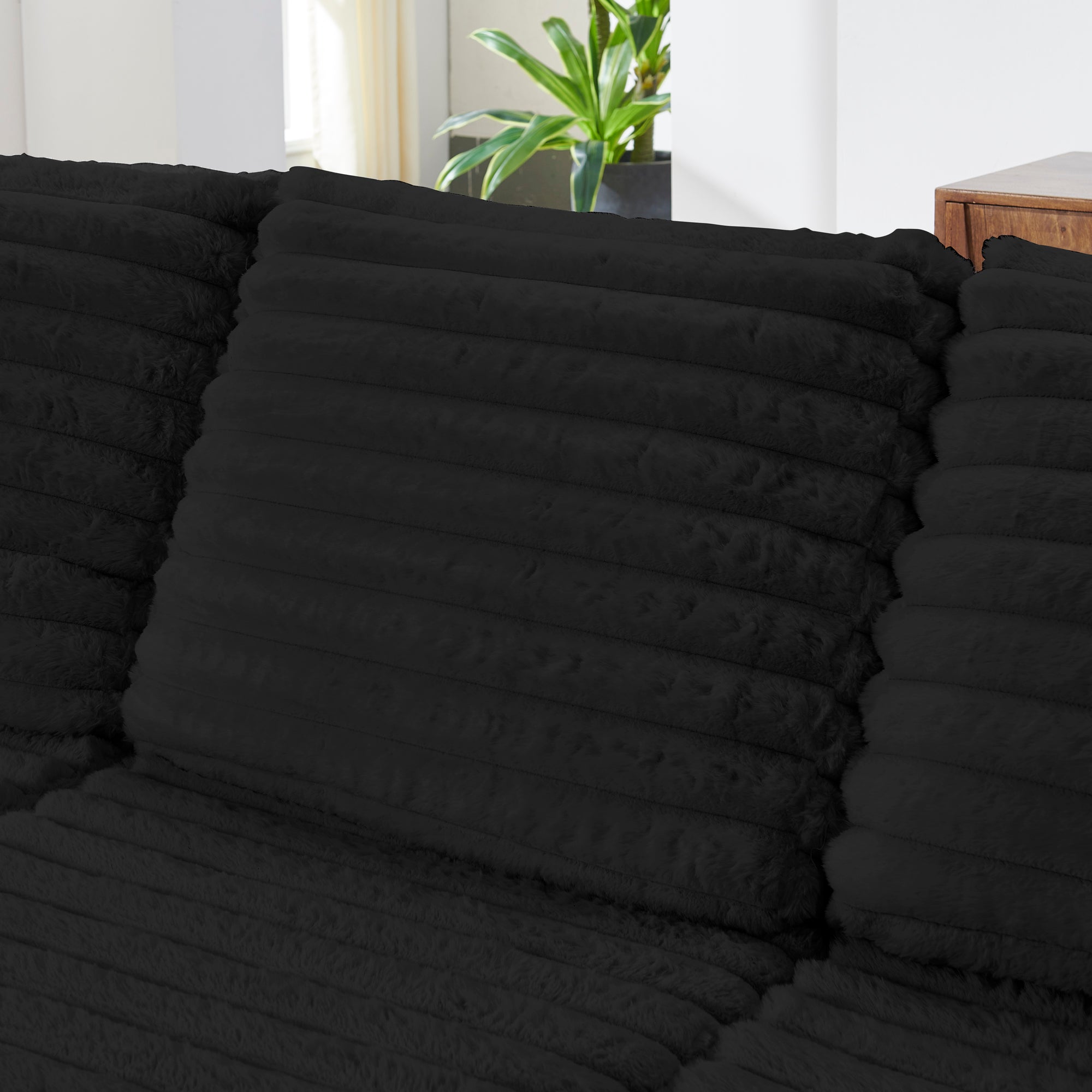 S101 Nuve black modular sectional sofa with ottomans in a living room